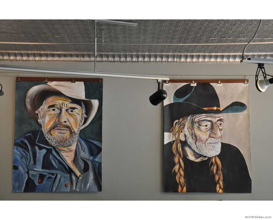 Various large portraits hang in the front part of Johnson Public House.