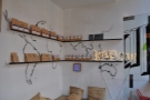 There are also plenty of bags of coffee for sale, arranged on the walls above the seat.
