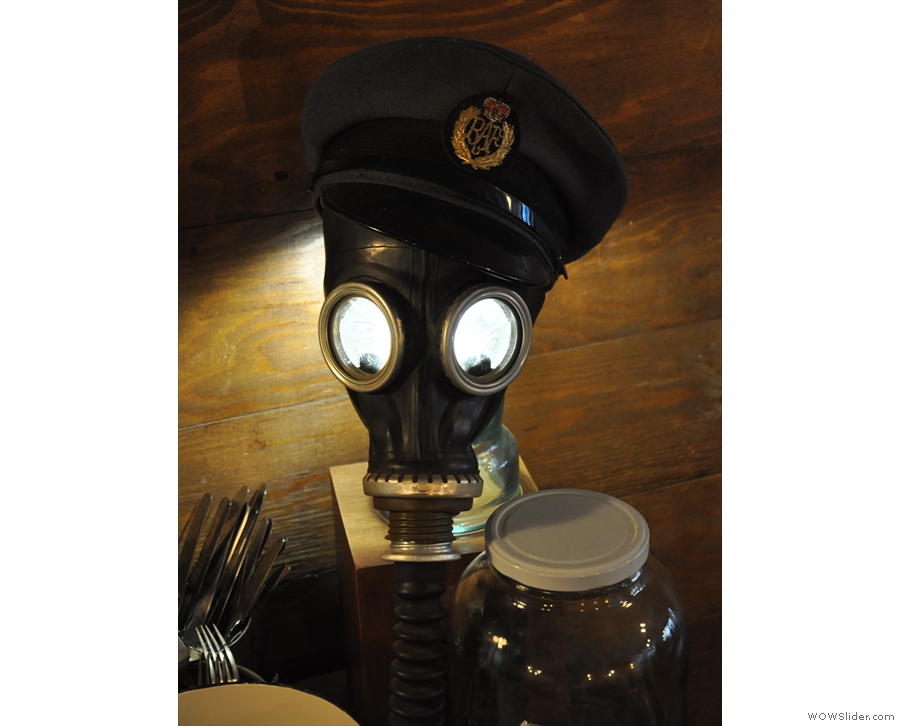 ... while this old gas-mask has been pressed into service as a light-fitting.