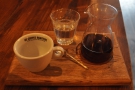 The presentation of the coffee is excellent, served on a wooden tray.