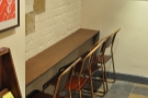 In 2014, against the opposite wall at the bottom of the stairs, was a four-seat bar...