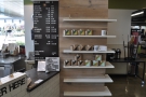 Kin-Kin is a roaster, coffee shop and retailer, with shelves to the right of the counter...