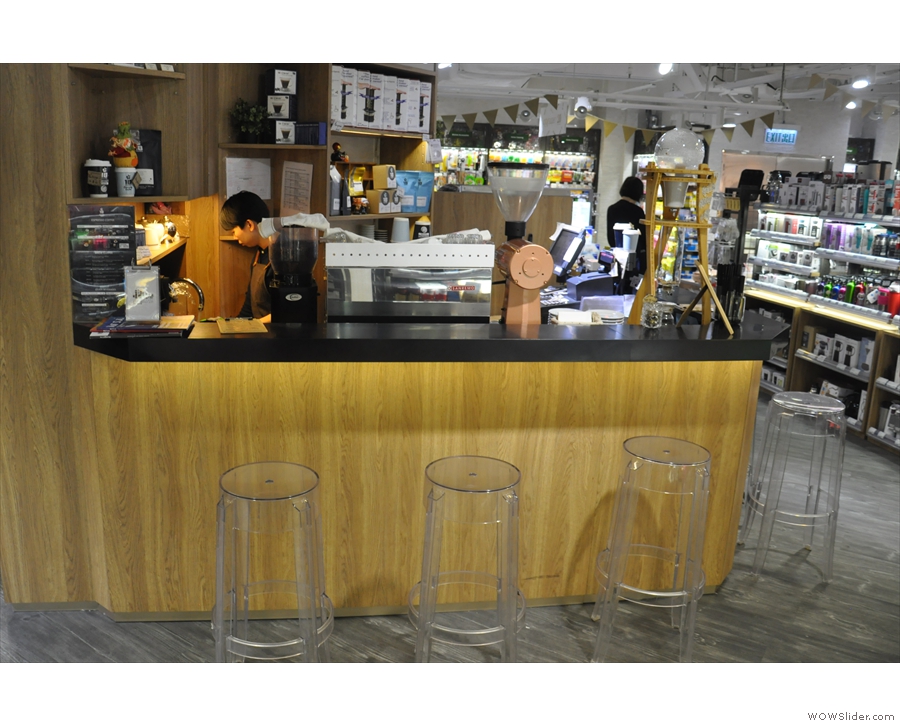 ... the triangular-shaped 18 Grams coffee stand. You can sit at either side of the counter.