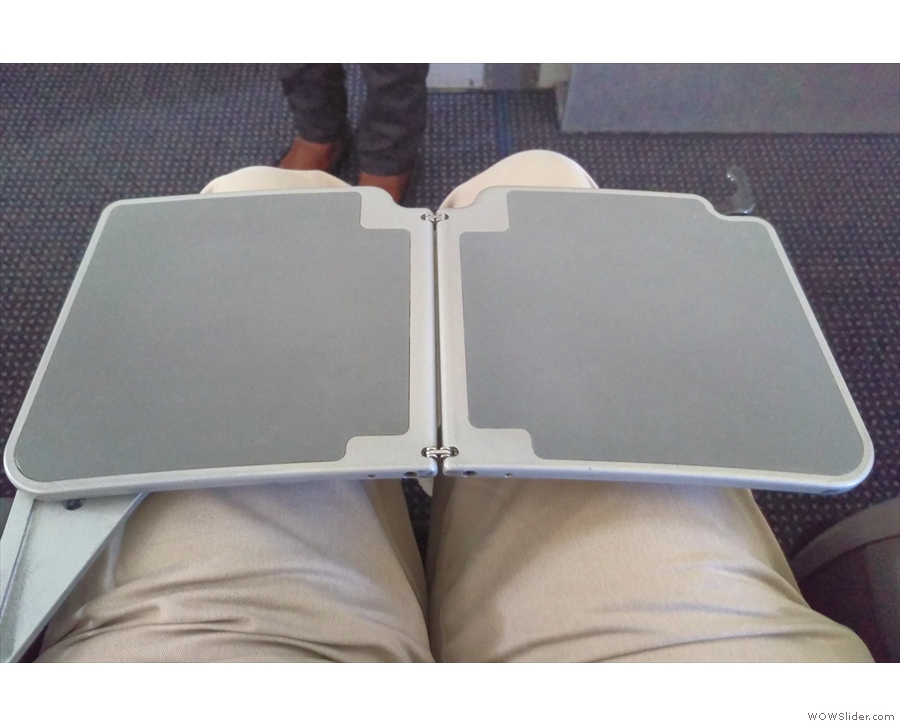 Exit row seats also mean fairly flimsy fold-out tables. It (just about) does the job!