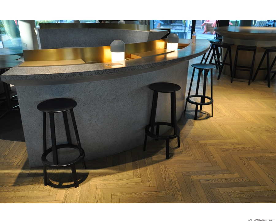A bar runs on the outside of each of the three segments, with seating provided by stools...