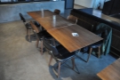 There is a row of two-person tables pushed together to form a set of two & one of three.