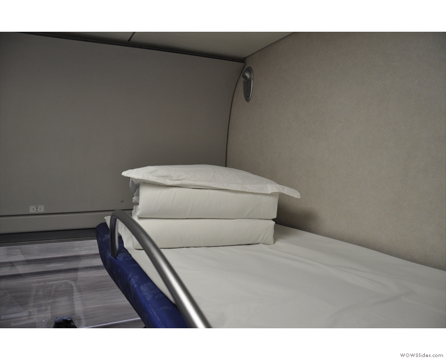Bedding is a pillow, a sheet and a duvet. A bar on the side of the upper bunk doubles...