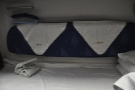 Padded cushions at the back allow the lower bunk to be used as seating during the day.