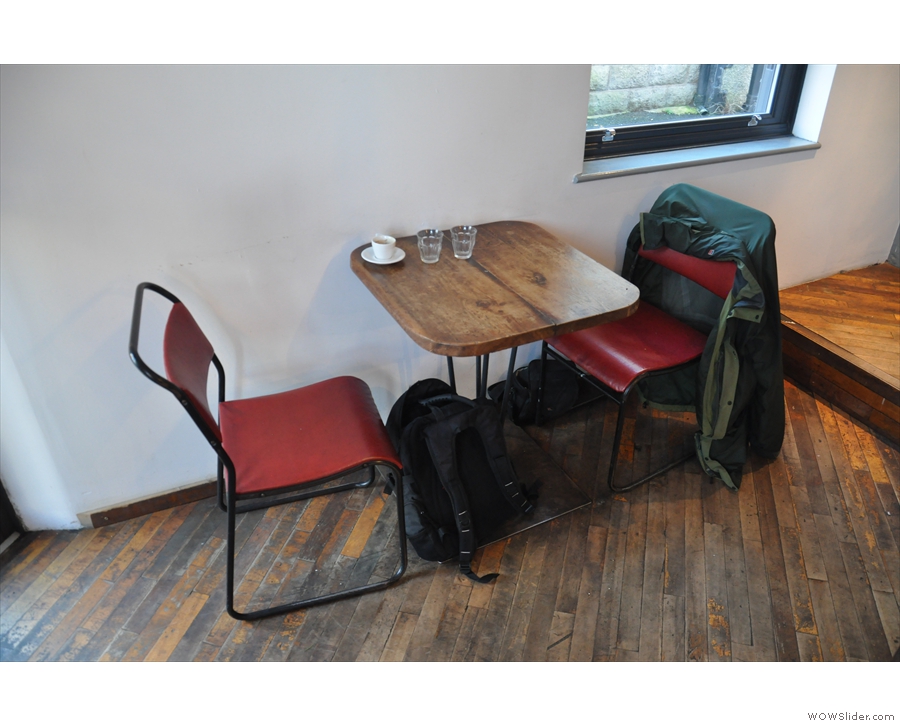 The remaining downstairs seating is a two-person table on the left-hand wall by the door.