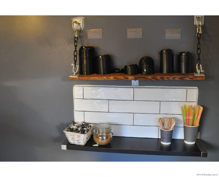 To the right, on the wall, a clever hanging tray arrangement acts as the takeaway station.