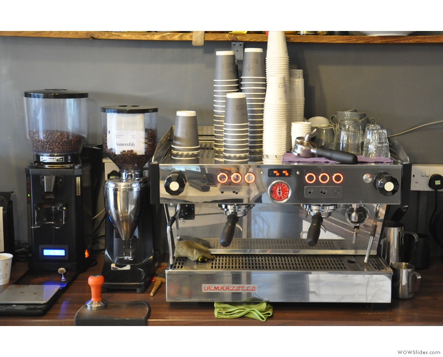 The La Marzocco espresso machine is also on the left-hand wall with its two grinders.