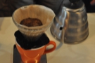 ... pausing between each pour to let the coffee filter through.