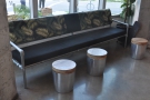 ... followed by the long sofa with small, cylindrical coffee tables.