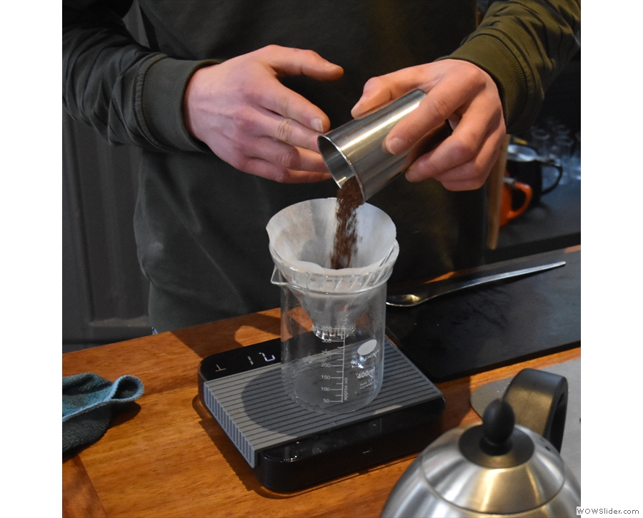 After rinsing the filter paper, Callum grinds the beans then puts them into the V60.