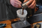 After rinsing the filter paper, Callum grinds the beans then puts them into the V60.