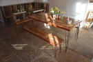 There's six-seater communal table in the centre of the room, with a pair of benches...
