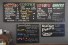 The menu is on a series of boards to the right of the counter.