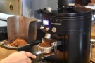 Although the grinder grinds and dispenses a set amount, Marissa will check it's correct...