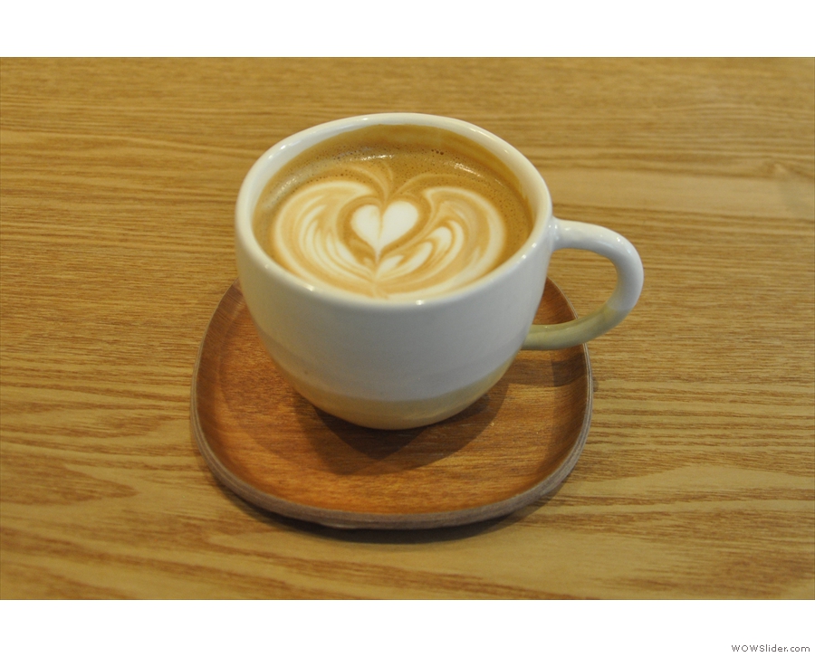 ... a creamy cappuccino, in fact, beautifully presented on a small wooden tray.