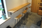 The bar is against the left-hand wall after the window. Check out the long, narrow stools.