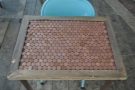 Like all of the two-person tables here, this one is decorated with old 2p coins.
