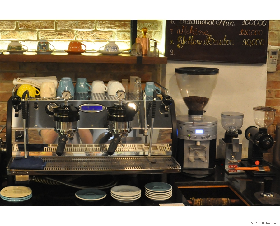The espresso machine, a two-group Strada, and its grinders are behind the counter.