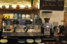 The espresso machine, a two-group Strada, and its grinders are behind the counter.