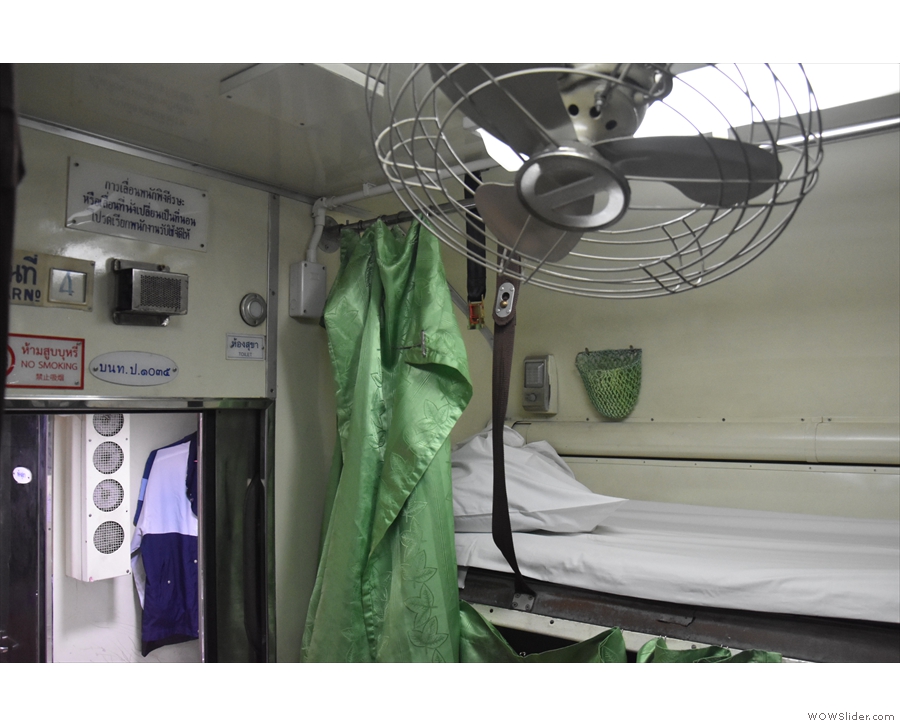 A green curtain can be drawn across each bunk for privacy...