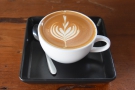 My flat white, made with the house blend, and served on a little tray.