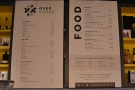 The menus are on the wall behind the till...