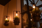 Neat features include each of the light-fittings doubling as a hanging-basket.