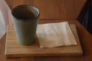 I'll leave you with my coffee, served in a handleless, cylindrical mug on a wooden tray.