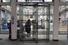 These revolving doors at the back might look like the way in, but the entrance is to the left.