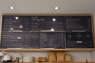 The main menu, with prices, is on the wall above/behind the counter.