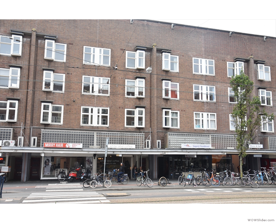 In West Amsterdam, on Jan Evertsenstraat, a parade of shops under a block of flats...