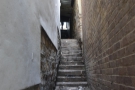 ... beyond which a narrow staircase between buildings leads up to Saddler Street...
