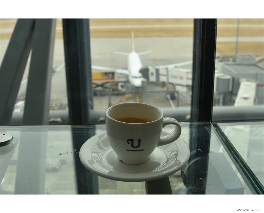 My coffee, overlooking a British Airways flight at the gate.