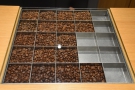 The beans are arranged in bins by roast profile, getting darker the further down you go.