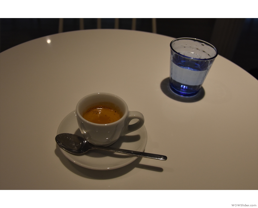 My espresso, served with a glass of sparkling water on the side.