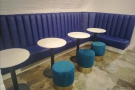... while off to the left, there's this neat niche with another padded bench and tables.