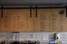 The menu is on the wall behind the counter.