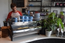 After the till, on the curved part of the counter, is the two-group La Marzocco Strada...