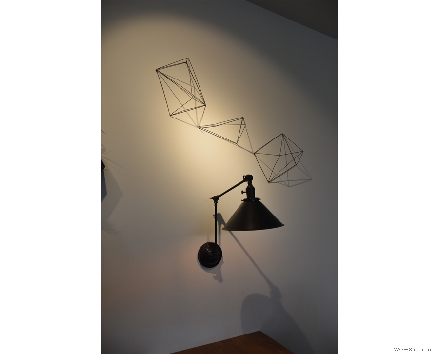 ... including these angle-poise lamps, one above each table on the back wall.