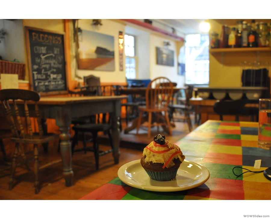 My cupcake surveys the warm, welcoming interior of Oystercatchers Cafe, Teignmouth