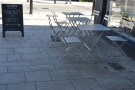 There's plenty of space on the well-shaded pavement for these three tables.