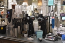 ... while behind the counter is the batch-brewer and a pair of EK-43 grinders.