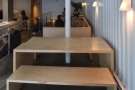 The seating consists of two of these tables, separated by a C-shaped bench.
