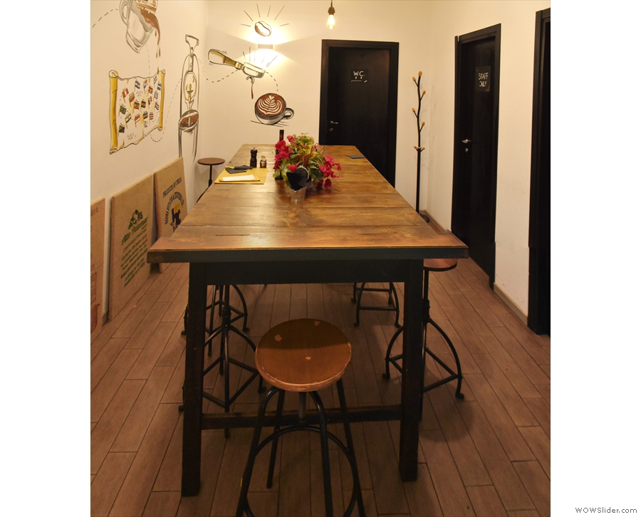 ... with a solitary eight-person communal table and some lovely wooden floorboards.