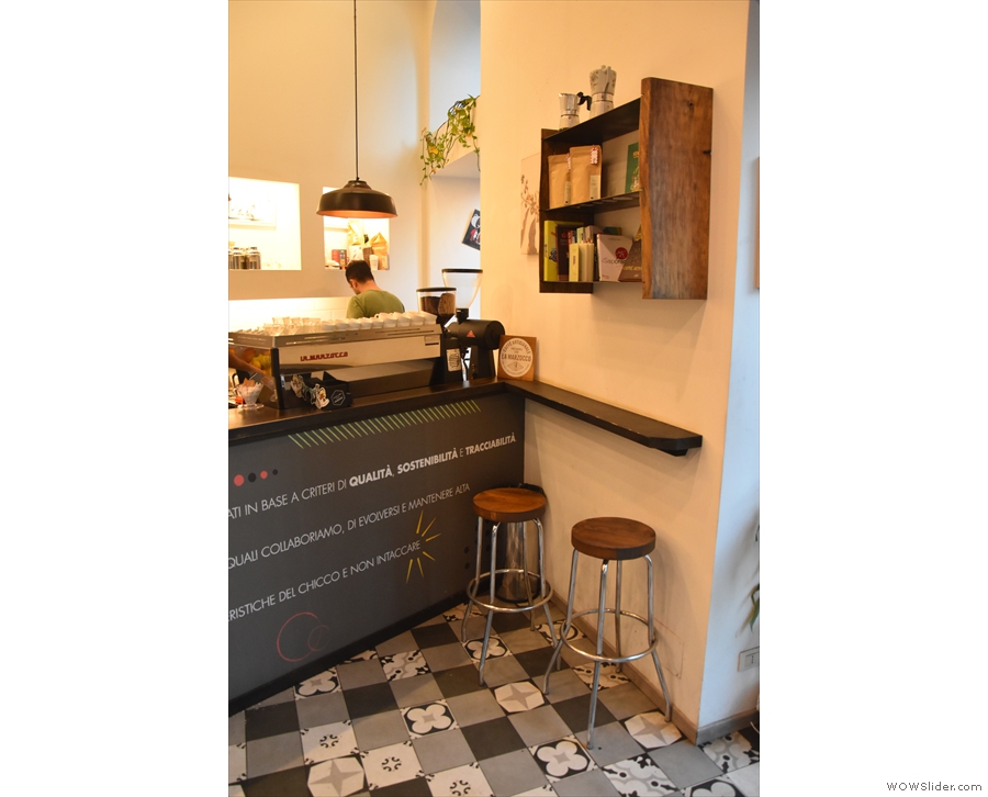 ... or you can sit on one of two stools at a narrow bar next to the espresso machine/door.