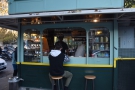 Three of the kiosk's sides have windows. This one faces Via Marmorata. And has stools.